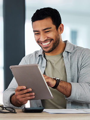 man looking at his tablet