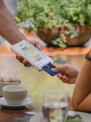 Someone using a point-of-sale tablet to pay for their food