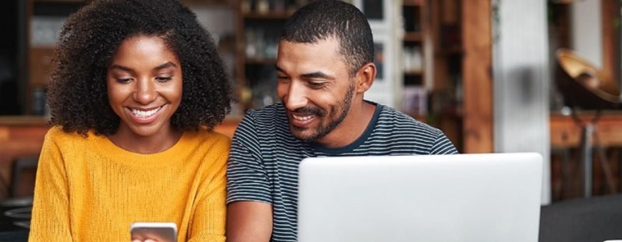 man and woman looking at a smart phone