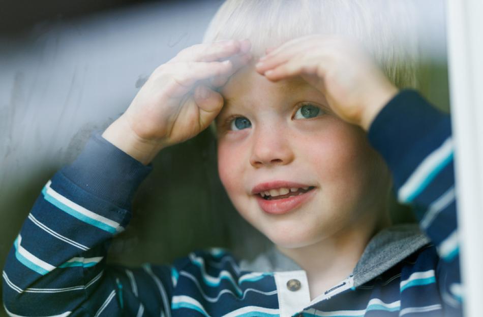 child looking out a window