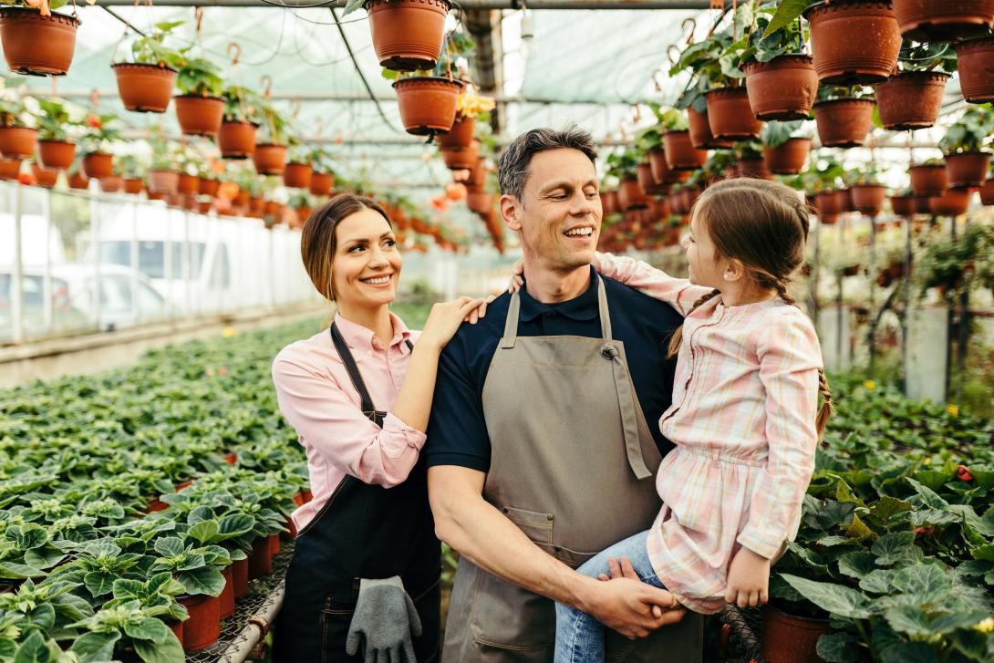 3 people walking around a greenhouse